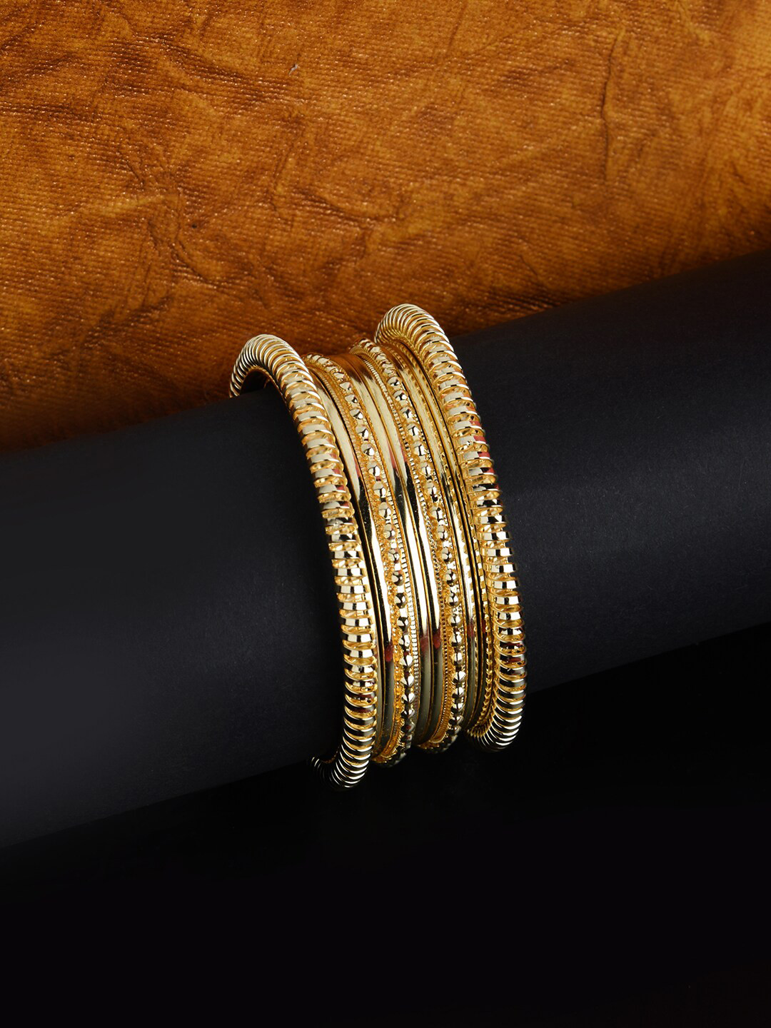 Gold bangle stack — the Infinity Bracelet design