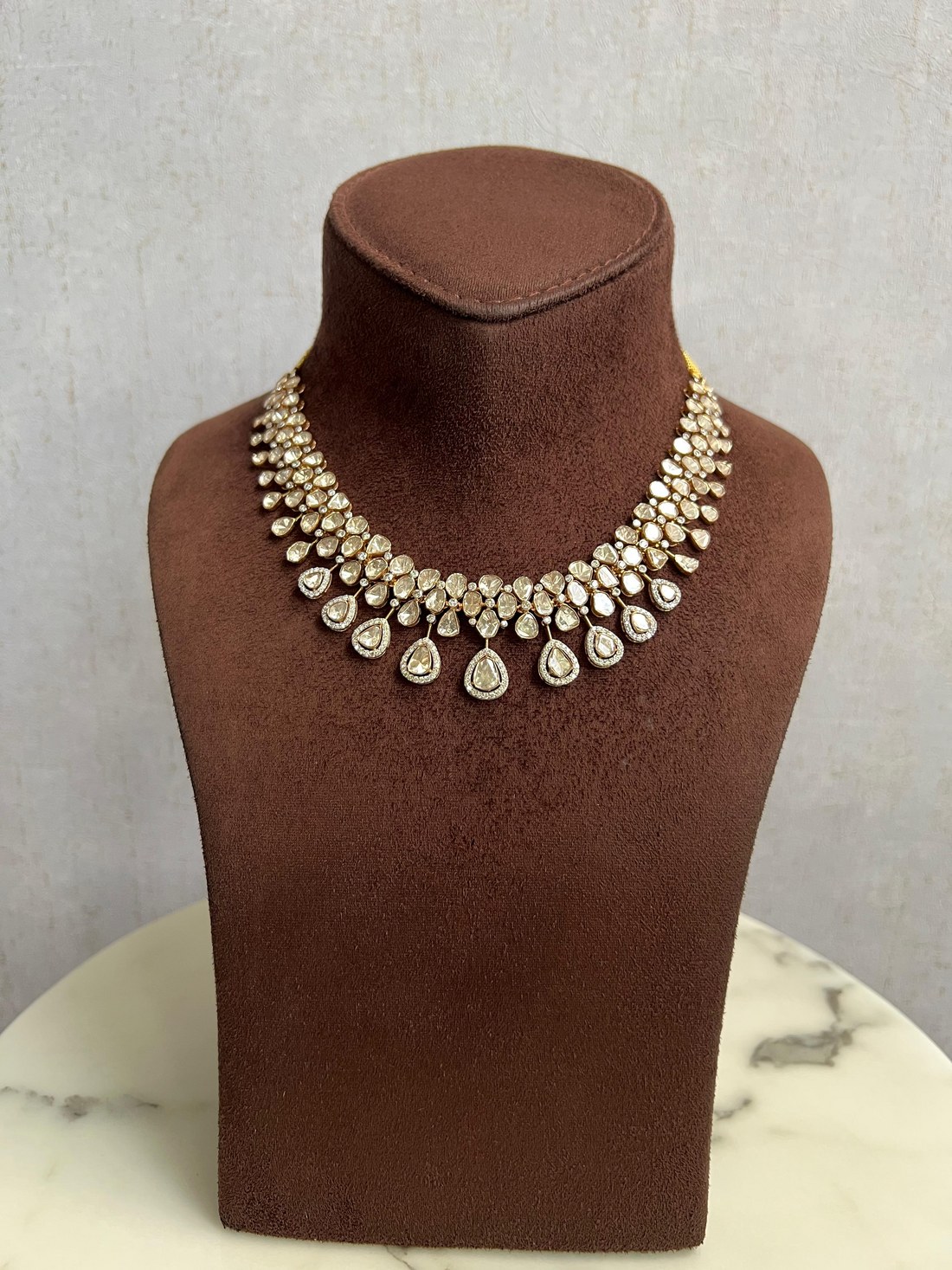 Polki diamond necklace on a showroom display bust